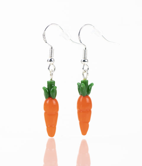 A pair of carrot themed earrings with orange and green carrot designed glass and sterling silver earring hook.