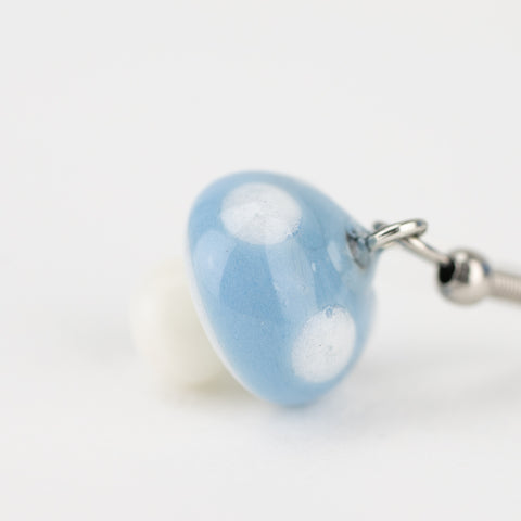 Handmade borosilicate blue mushroom earrings on white background
