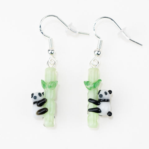 Cute handmade glass earrings featuring pandas climbing bamboo