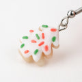 Festive Christmas sugar cookie earrings on white background